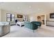 Bright main bedroom featuring a sitting area, carpet floors, and neutral wall paint at 2635 S Monroe St, Denver, CO 80210