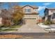 Two-story house with attached garage and autumn landscaping at 14449 E 101St Pl, Commerce City, CO 80022