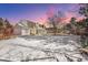 Large, snowy backyard featuring mature trees and a charming fence, offering privacy and space for outdoor enjoyment at 6330 E Irwin Pl, Centennial, CO 80112