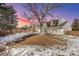 Expansive backyard with mature trees and a snow-covered lawn, perfect for outdoor activities and enjoying nature at 6330 E Irwin Pl, Centennial, CO 80112