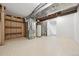 Unfinished basement featuring painted floor, utilities, and open space with a doorway and potential for customization at 6330 E Irwin Pl, Centennial, CO 80112