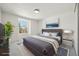 Bright bedroom featuring a comfortable bed, neutral tones, and a large window that fills the space with natural light at 6330 E Irwin Pl, Centennial, CO 80112