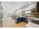 Well-lit kitchen showcasing blue lower cabinets, light wood upper cabinets, a bright quartz counter, and stainless steel appliances at 6330 E Irwin Pl, Centennial, CO 80112