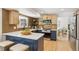 Modern kitchen featuring stylish blue cabinets, a quartz countertop island, stainless steel appliances, and hardwood floors at 6330 E Irwin Pl, Centennial, CO 80112