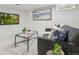 Cozy living room featuring a comfortable sofa, a modern glass coffee table, and tasteful decor for relaxation at 6330 E Irwin Pl, Centennial, CO 80112