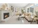 Cozy living room with a brick fireplace, built-in shelves, neutral tones, and large windows for ample light at 6330 E Irwin Pl, Centennial, CO 80112