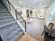 Inviting entryway featuring a staircase with metal railings, leading to a spacious living area with neutral décor at 6330 E Irwin Pl, Centennial, CO 80112