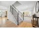 Bright entryway with a staircase, leading to a living room with neutral decor, white sofas, and stylish artwork at 6330 E Irwin Pl, Centennial, CO 80112