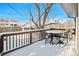 Snow covered deck with table and chairs, overlooking backyard at 1859 S Saulsbury Ct, Lakewood, CO 80232