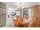 Bright dining area with a wooden table and chairs, kitchen view at 1859 S Saulsbury Ct, Lakewood, CO 80232