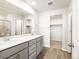 Large bathroom features double sinks, quartz counters, grey cabinets and a walk-in closet at 22360 E 8Th Ave, Aurora, CO 80018