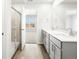 This bathroom has a shower, gray cabinets, double sinks, white counters, and plenty of space at 22360 E 8Th Ave, Aurora, CO 80018