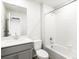 Bright bathroom featuring white tiled shower and gray vanity at 22360 E 8Th Ave, Aurora, CO 80018