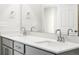 Clean bathroom features a double sink vanity with gray cabinets, white counters, and a large mirror at 22360 E 8Th Ave, Aurora, CO 80018