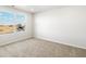 Well-lit bedroom features neutral carpet, and a window with a construction view at 22360 E 8Th Ave, Aurora, CO 80018