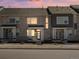 Charming townhouse boasts a stylish stone facade and modern design elements with a colorful sky at 22360 E 8Th Ave, Aurora, CO 80018