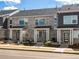 Attractive townhouses featuring stone facade, modern design, and well-maintained front yard landscaping at 22360 E 8Th Ave, Aurora, CO 80018