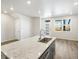 Bright kitchen featuring a large center island with a sink and views of the front entrance at 22360 E 8Th Ave, Aurora, CO 80018