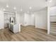 Open-concept living space with modern kitchen, light wood floors, and staircase at 22360 E 8Th Ave, Aurora, CO 80018