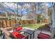 Well-maintained backyard has mature trees and an outdoor seating area with a wood fence at 5275 Holmes Pl, Boulder, CO 80303