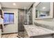 Bathroom with a glass-enclosed shower, marble countertop, modern fixtures, and stylish tiling at 5275 Holmes Pl, Boulder, CO 80303