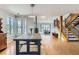 Open-concept dining room with a large wooden table, staircase, and plenty of natural light at 5275 Holmes Pl, Boulder, CO 80303