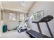 Bright exercise room with natural light, treadmill, stationary bike, and equipment for workouts at 5275 Holmes Pl, Boulder, CO 80303