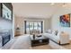 Bright living room with vaulted ceiling, a fireplace, and large windows at 5275 Holmes Pl, Boulder, CO 80303