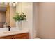 Modern bathroom showcasing a wood vanity, a stylish sink, and a decorative mirror at 4822 Bandera Pl, Parker, CO 80134