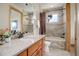 Well-lit bathroom features a granite countertop, modern fixtures, and tiled shower and tub at 4822 Bandera Pl, Parker, CO 80134