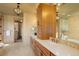Luxurious bathroom featuring double vanities, custom cabinets, a soaking tub, and stylish fixtures at 4822 Bandera Pl, Parker, CO 80134