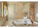 Spa-like bathroom features a soaking tub with tile surround, a walk-in shower, and natural light at 4822 Bandera Pl, Parker, CO 80134