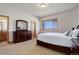 Comfortable bedroom with a view, featuring a large dresser and neutral decor at 4822 Bandera Pl, Parker, CO 80134