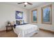 Bright bedroom with carpet flooring features natural light, and a modern design with warm wood trim at 4822 Bandera Pl, Parker, CO 80134