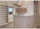 Organized walk-in closet with custom shelving, ample storage space, and a stylish chandelier at 4822 Bandera Pl, Parker, CO 80134