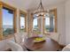 Cozy dining area with a round table, upholstered chairs, and scenic views from surrounding windows at 4822 Bandera Pl, Parker, CO 80134