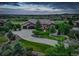 Beautiful exterior with lush landscaping, stone facade, circular driveway leading to an attached two-car garage, and horizon views at 4822 Bandera Pl, Parker, CO 80134