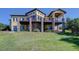 Beautiful exterior view of a spacious home with balconies, stone accents, and lush greenery at 4822 Bandera Pl, Parker, CO 80134