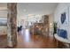 Beautiful foyer featuring hardwood floors, a stone pillar, and a decorative staircase with an iron railing at 4822 Bandera Pl, Parker, CO 80134