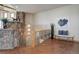 Open hallway showcases a decorative stone wall, railing detail, and wood flooring, adding architectural interest at 4822 Bandera Pl, Parker, CO 80134