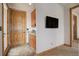 Convenient hallway with wet bar, access to the outside, and a mounted TV, adding functionality at 4822 Bandera Pl, Parker, CO 80134