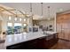An open kitchen flows into a cozy living area with a stone fireplace and beamed ceiling at 4822 Bandera Pl, Parker, CO 80134