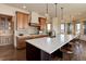 Bright, spacious kitchen featuring a large island, custom cabinetry, and stone backsplash at 4822 Bandera Pl, Parker, CO 80134