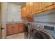 Functional laundry room featuring modern washer and dryer, storage cabinets, and sink at 4822 Bandera Pl, Parker, CO 80134