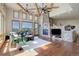 Bright living room with beamed ceilings, a stone fireplace, and large windows offering scenic views at 4822 Bandera Pl, Parker, CO 80134