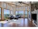 A spacious living room features beamed ceilings, large windows, and stone fireplace with stunning views at 4822 Bandera Pl, Parker, CO 80134
