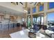 Sunlit living area with soaring ceilings that connects to the kitchen and dining room at 4822 Bandera Pl, Parker, CO 80134
