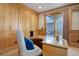 Bright office features glass-topped desk and backyard access, blending work with seamless indoor-outdoor living at 4822 Bandera Pl, Parker, CO 80134