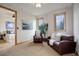 Cozy sitting room with leather furnishings, bathed in natural light, adjoins the bedroom for added comfort at 4822 Bandera Pl, Parker, CO 80134