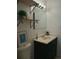 This bathroom features updated vanity, modern mirror and lighting, and neutral paint at 5640 E 67Th Pl, Commerce City, CO 80022